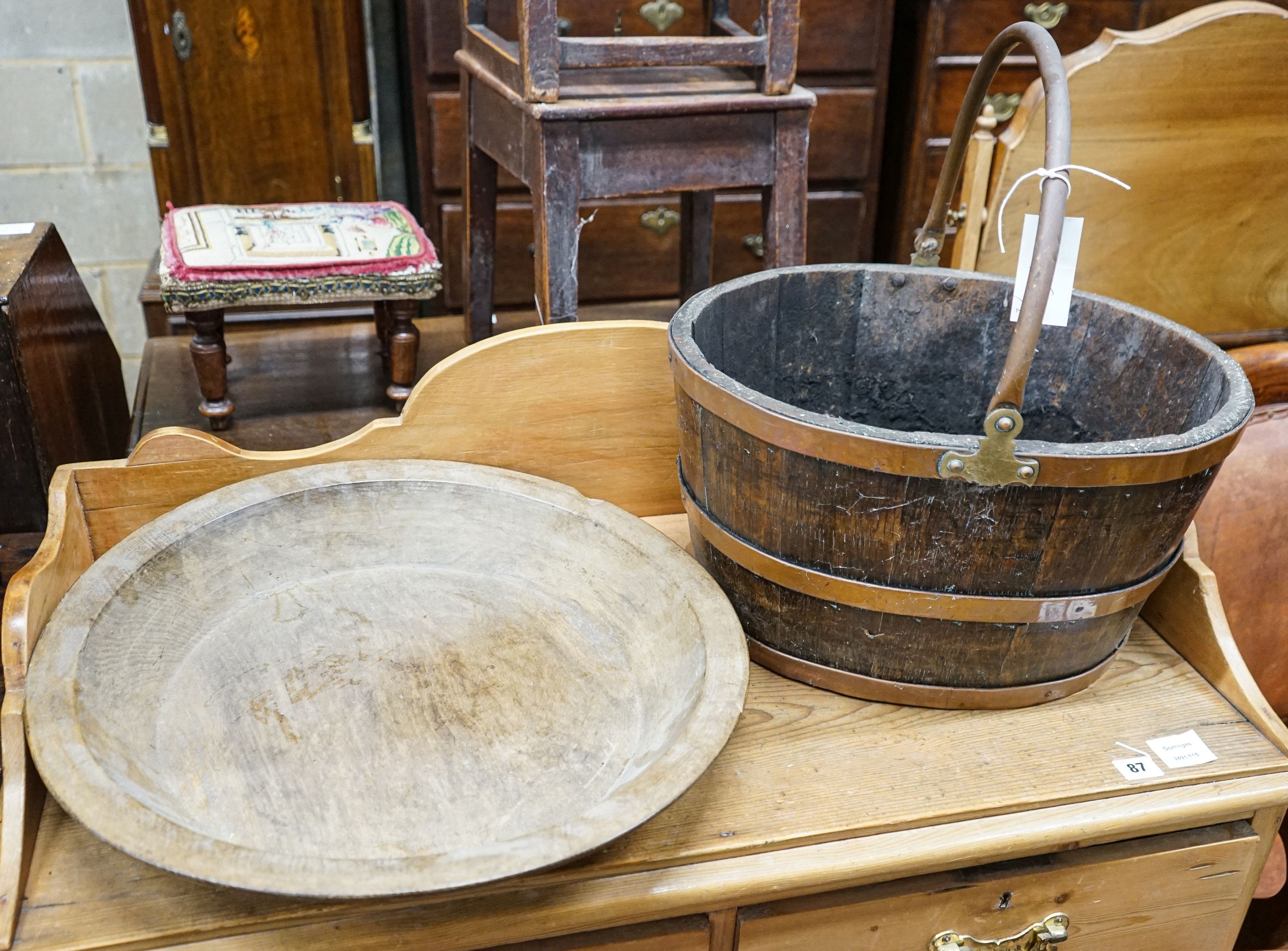 A copper bound staved oak log basket, width 45cm, depth 36cm, together with a circular turned beech bowl, 51cm